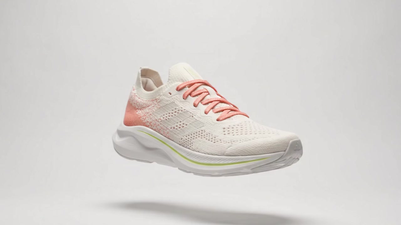 The Aero One in off-white knit with coral laces, floating above its shadow