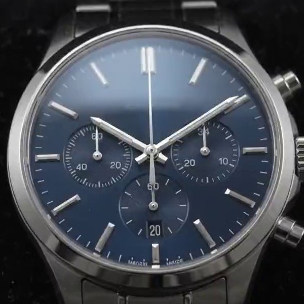 Top-down view of the navy sunburst dial with three chronograph registers and a date window at six o'clock